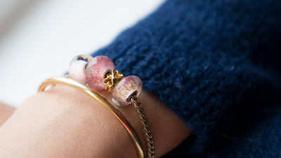 Trollbeads Copper bangle and twisted silver bangle with heart shaped gold bead and strawberry quartz bead