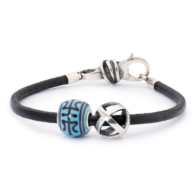 Bracelet with black cord, blue bead, and silver clasp on a white background