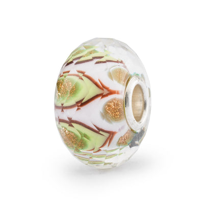 Captivating faceted glass bead with a swirling mix of green shades and a touch of golden glimmer.