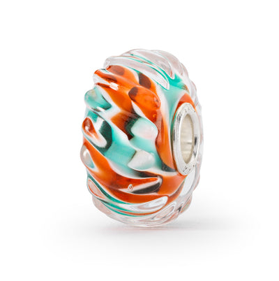 A colorful glass bead with a wavy shape, featuring vibrant shades of orange, turquoise, and white.