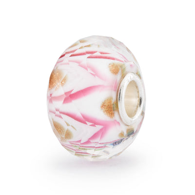 A stunning faceted glass bead with a beautiful pink swirl pattern reminiscent of a symphony, with intricate details that create a sense of movement.