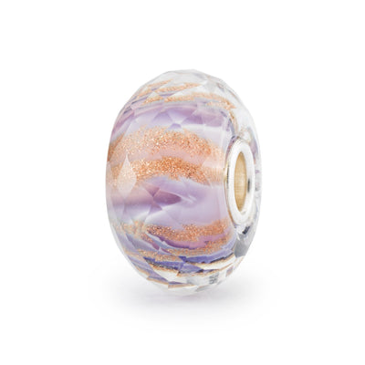 A stunning faceted glass bead with a delicate lilac hue and gold glimmer patterns.