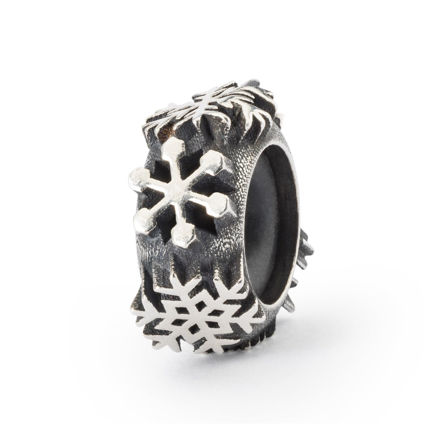 Silver spacer with different designs of snowflakes encrusted all around the spacer. The core of the spacer is made of rubber.