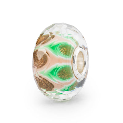 Mesmerizing faceted glass bead with a mix of green and pale pink hues, inspired by a mandala pattern.
