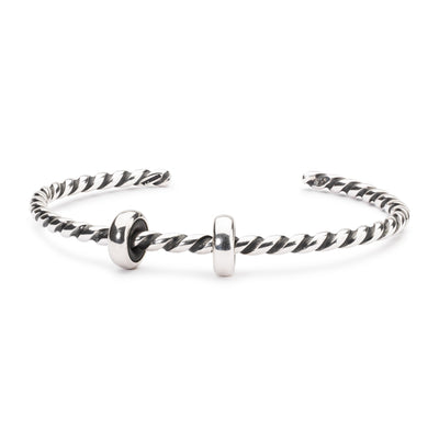 Twisted silver bangle with two silver spacers, providing a simple yet elegant foundation for your Trollbeads bracelet.